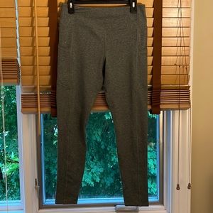 Size L, never worn, grey leggings with two side pockets.